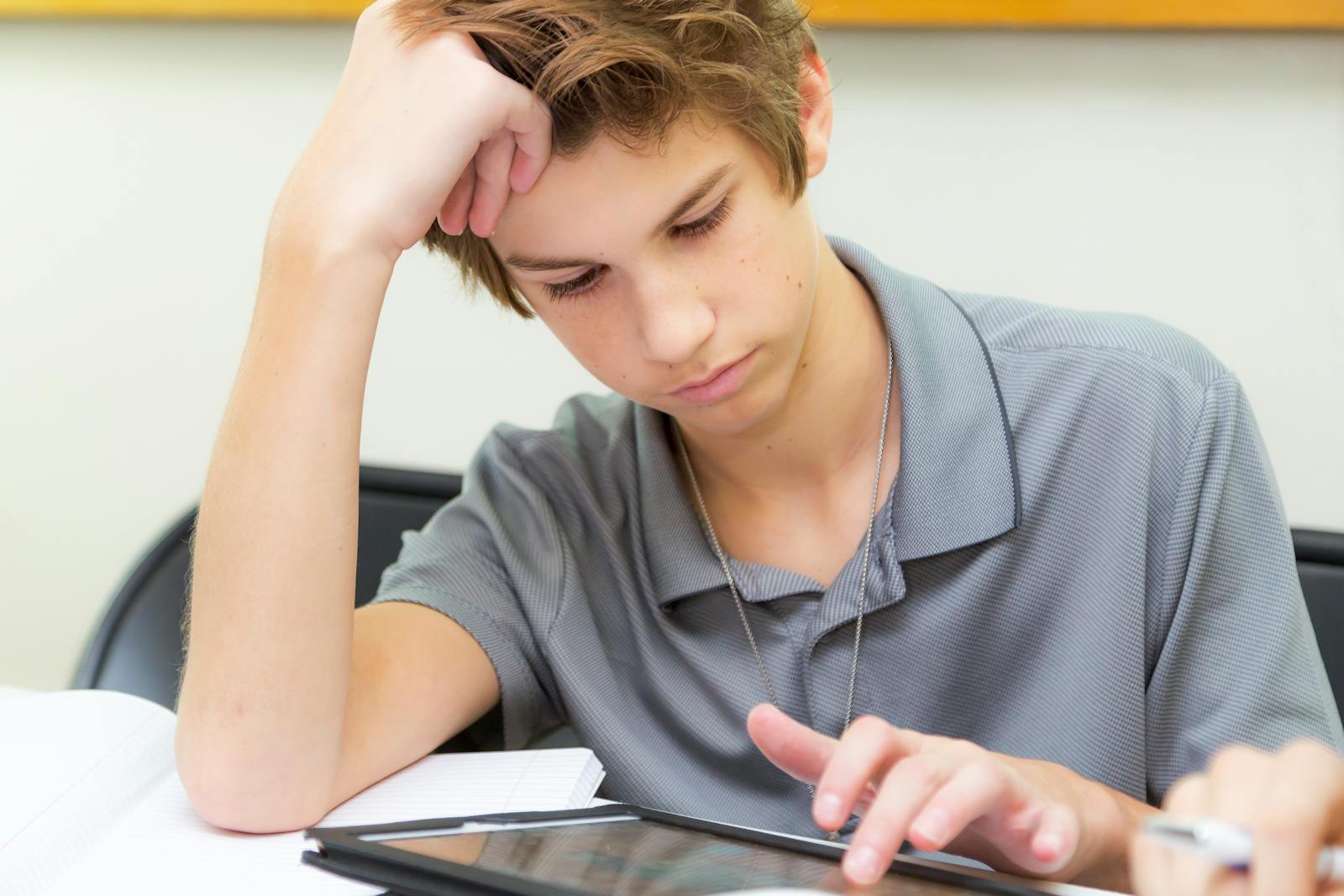 Teen student using a tablet in a classroom